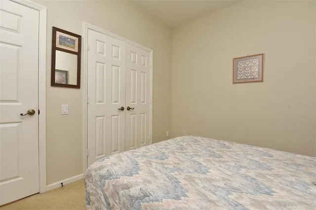 a view of a bedroom with wooden floor and closet