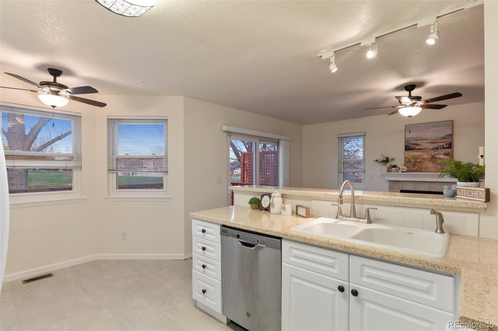 12734 Eudora Drive Thornton, CO 80241 - Photo 13 of 49 a bathroom with a double vanity sink a mirror and a shower