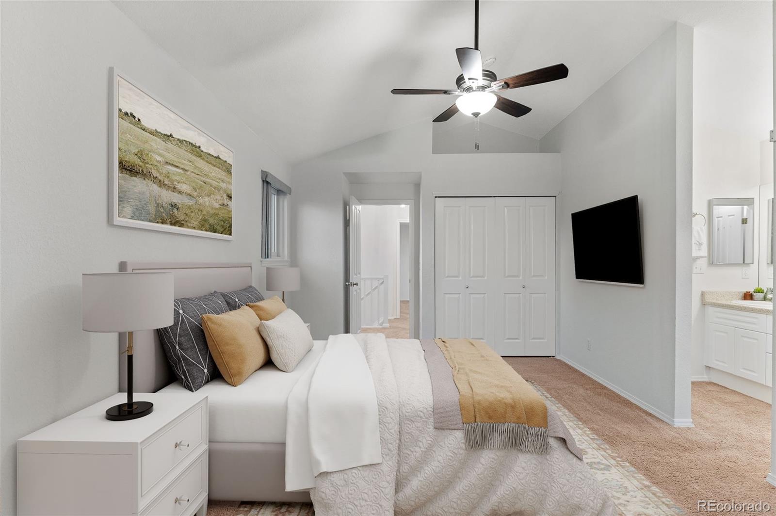 12734 Eudora Drive Thornton, CO 80241 - Photo 20 of 49 a bedroom with a bed and a flat screen tv