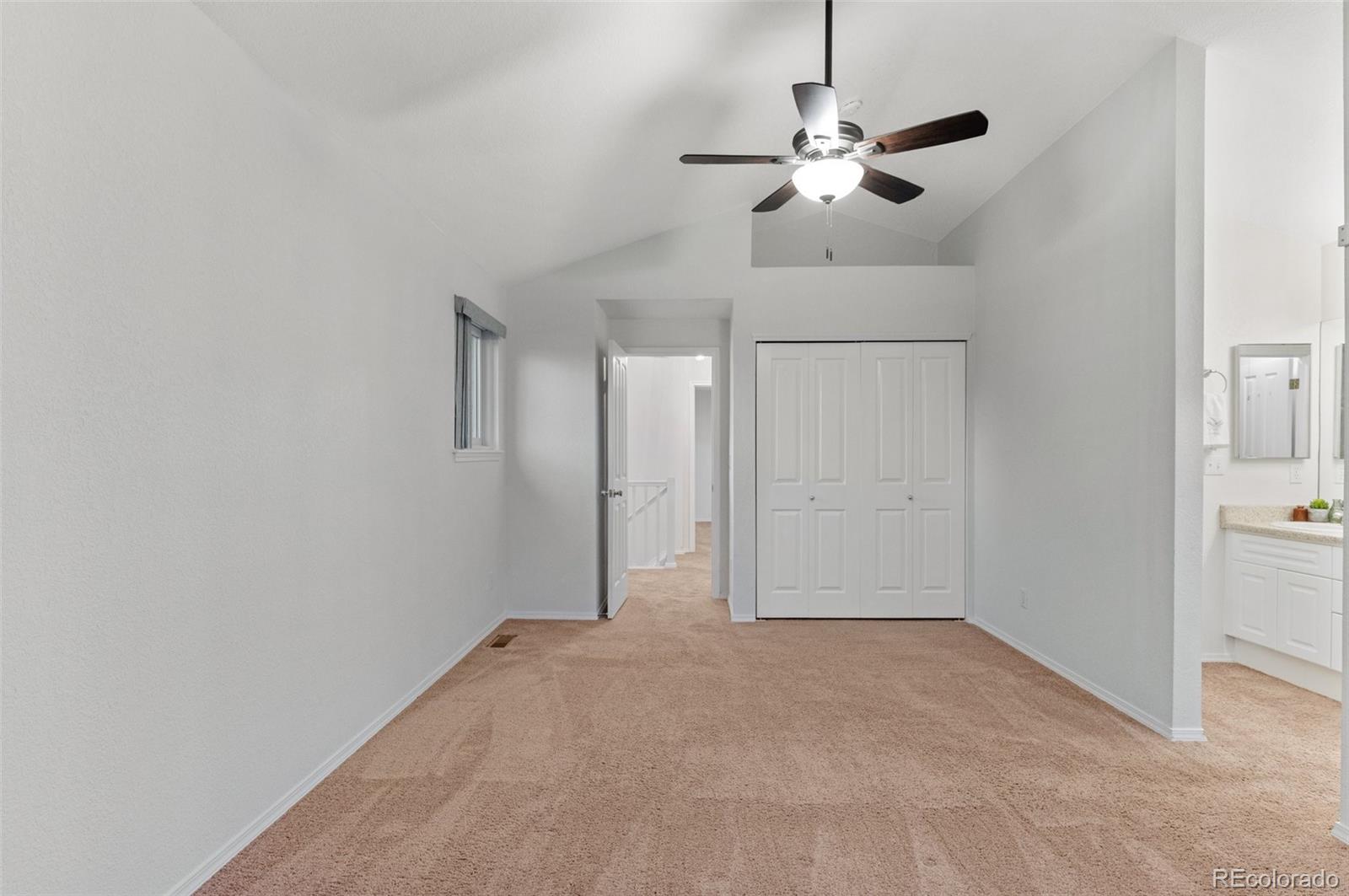 12734 Eudora Drive Thornton, CO 80241 - Photo 21 of 49 en empty room with window and ceiling fan