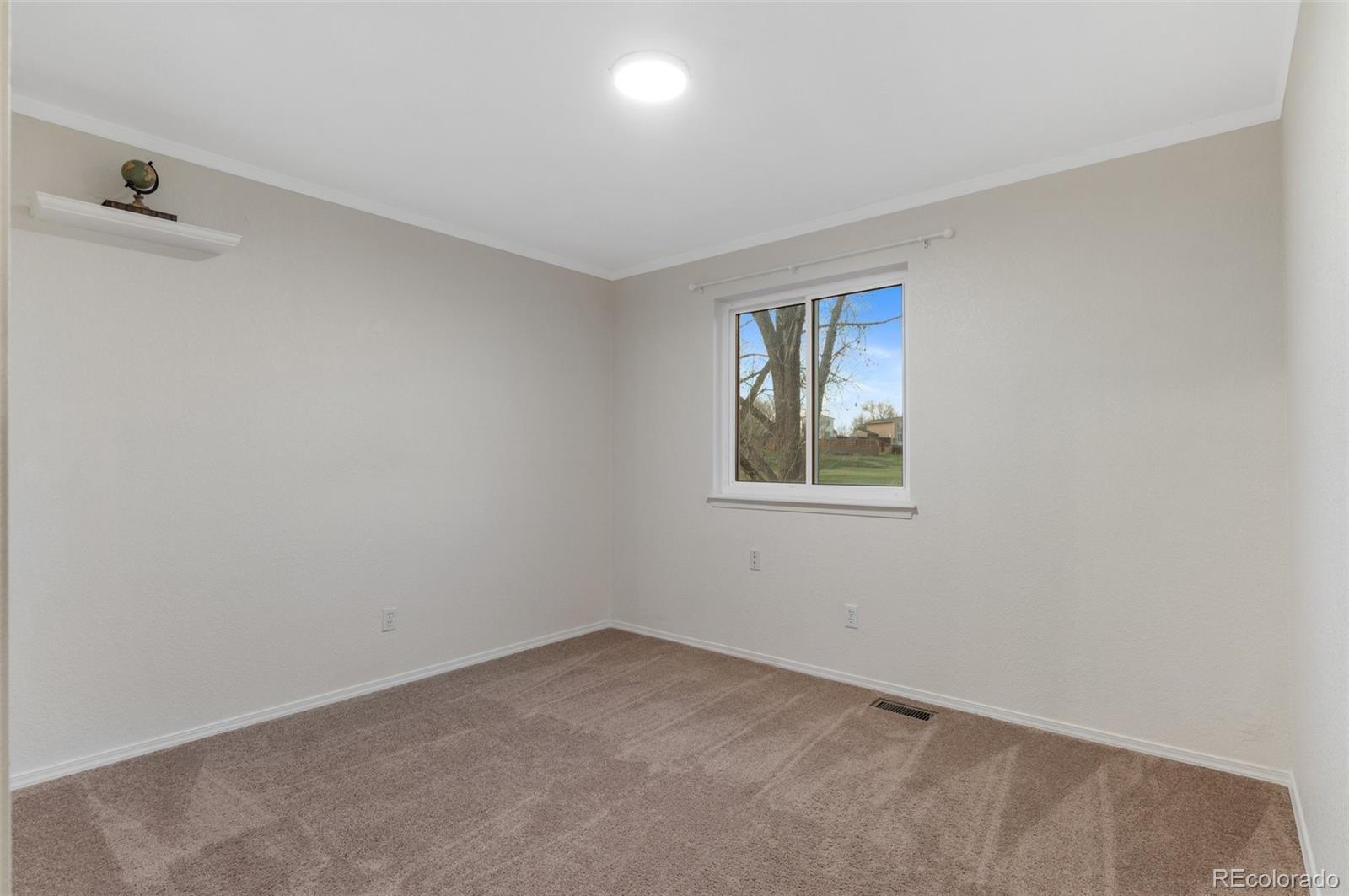 12734 Eudora Drive Thornton, CO 80241 - Photo 25 of 49 an empty room with windows