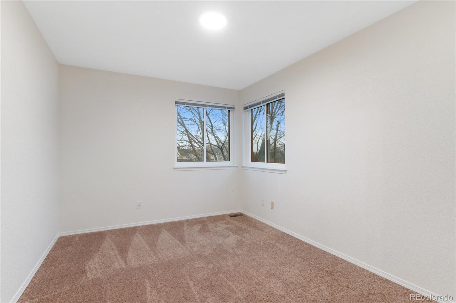 12734 Eudora Drive Thornton, CO 80241 - Photo 26 of 49 an empty room with windows