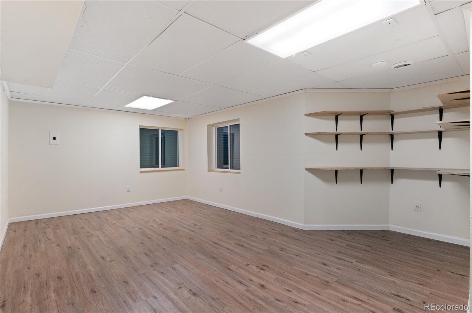 12734 Eudora Drive Thornton, CO 80241 - Photo 30 of 49 a view of an empty room with wooden floor and a window