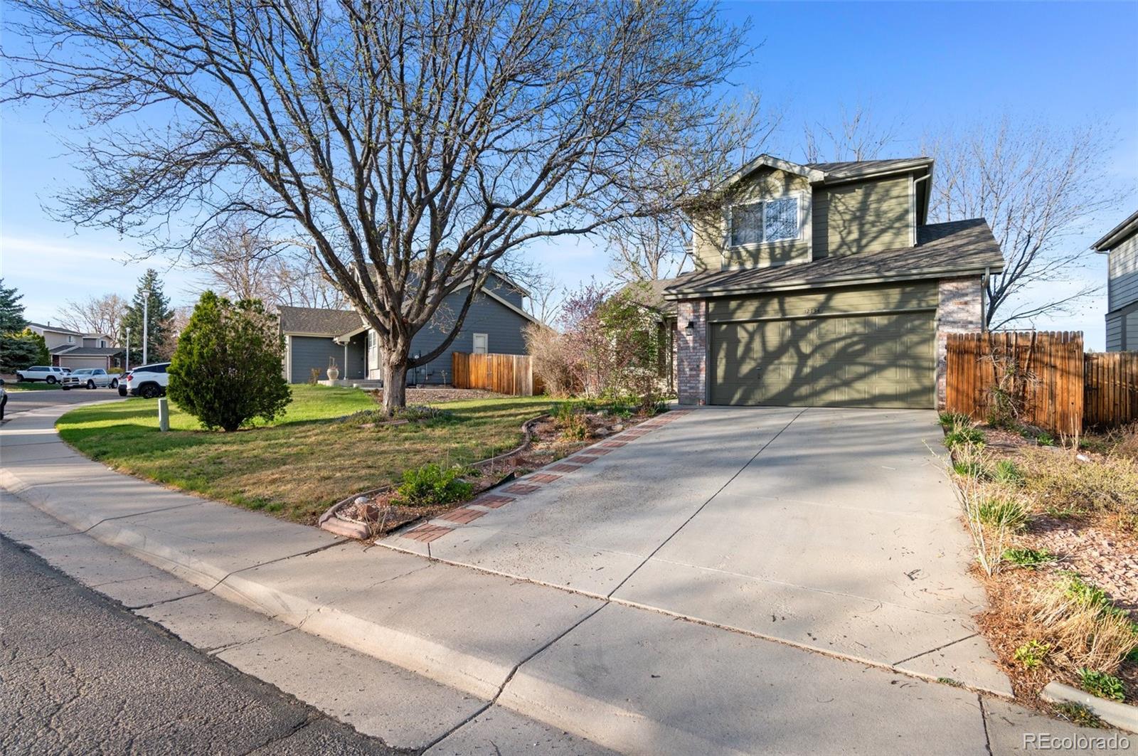 12734 Eudora Drive Thornton, CO 80241 - Photo 3 of 49 a front view of a house with garden