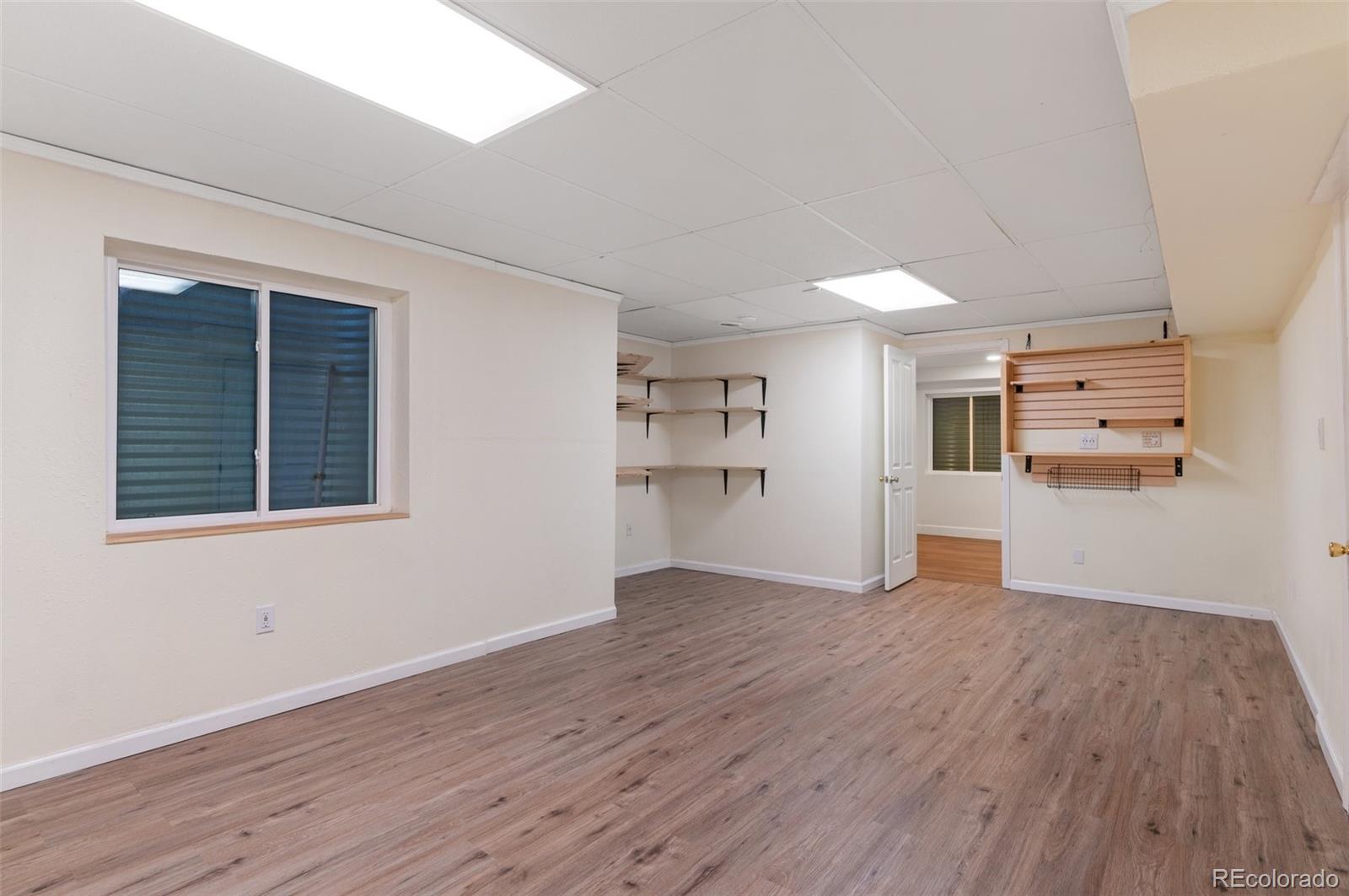 12734 Eudora Drive Thornton, CO 80241 - Photo 31 of 49 a view of a kitchen with wooden floor and windows