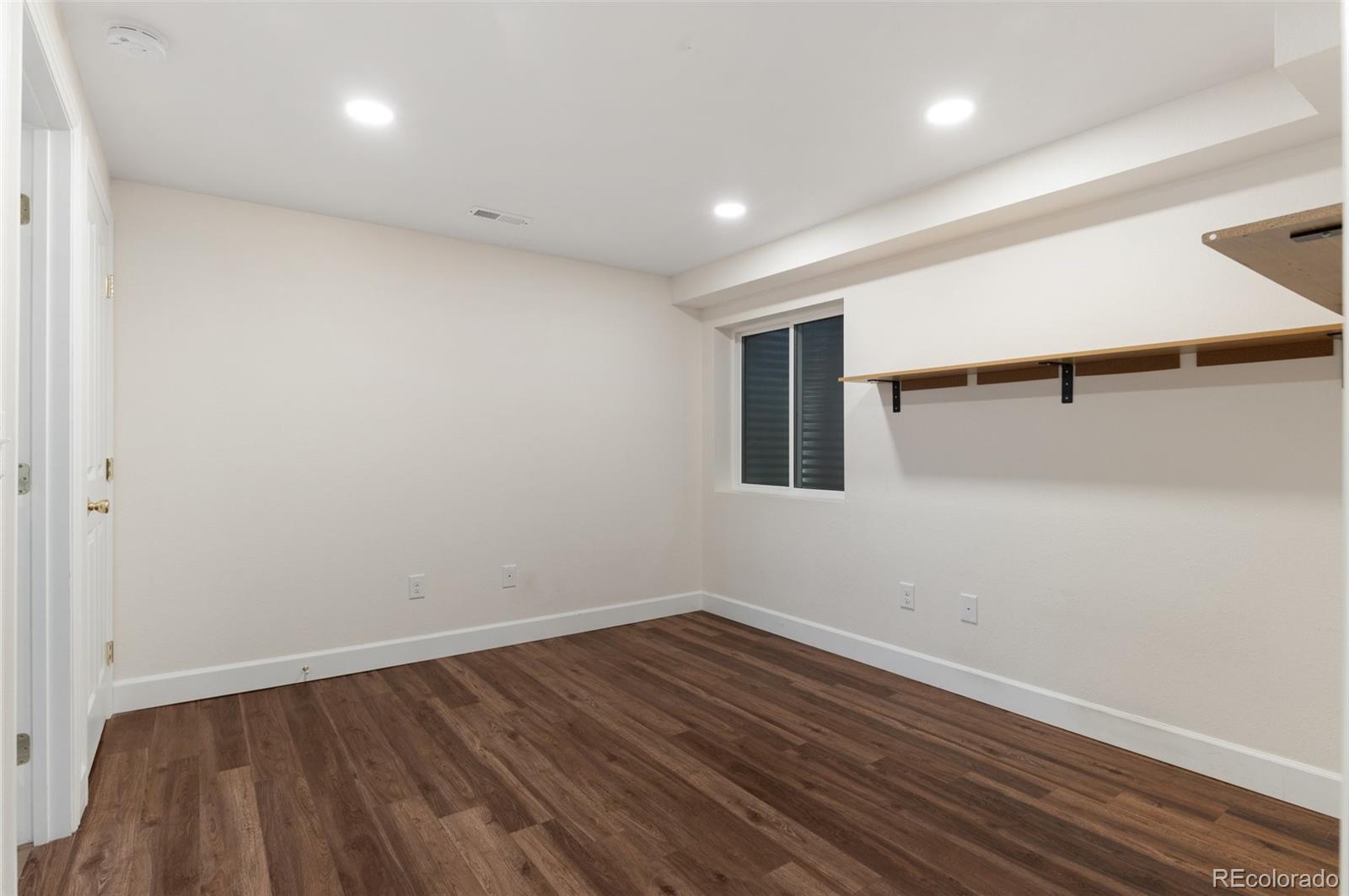 12734 Eudora Drive Thornton, CO 80241 - Photo 32 of 49 a view of a room with wooden floor