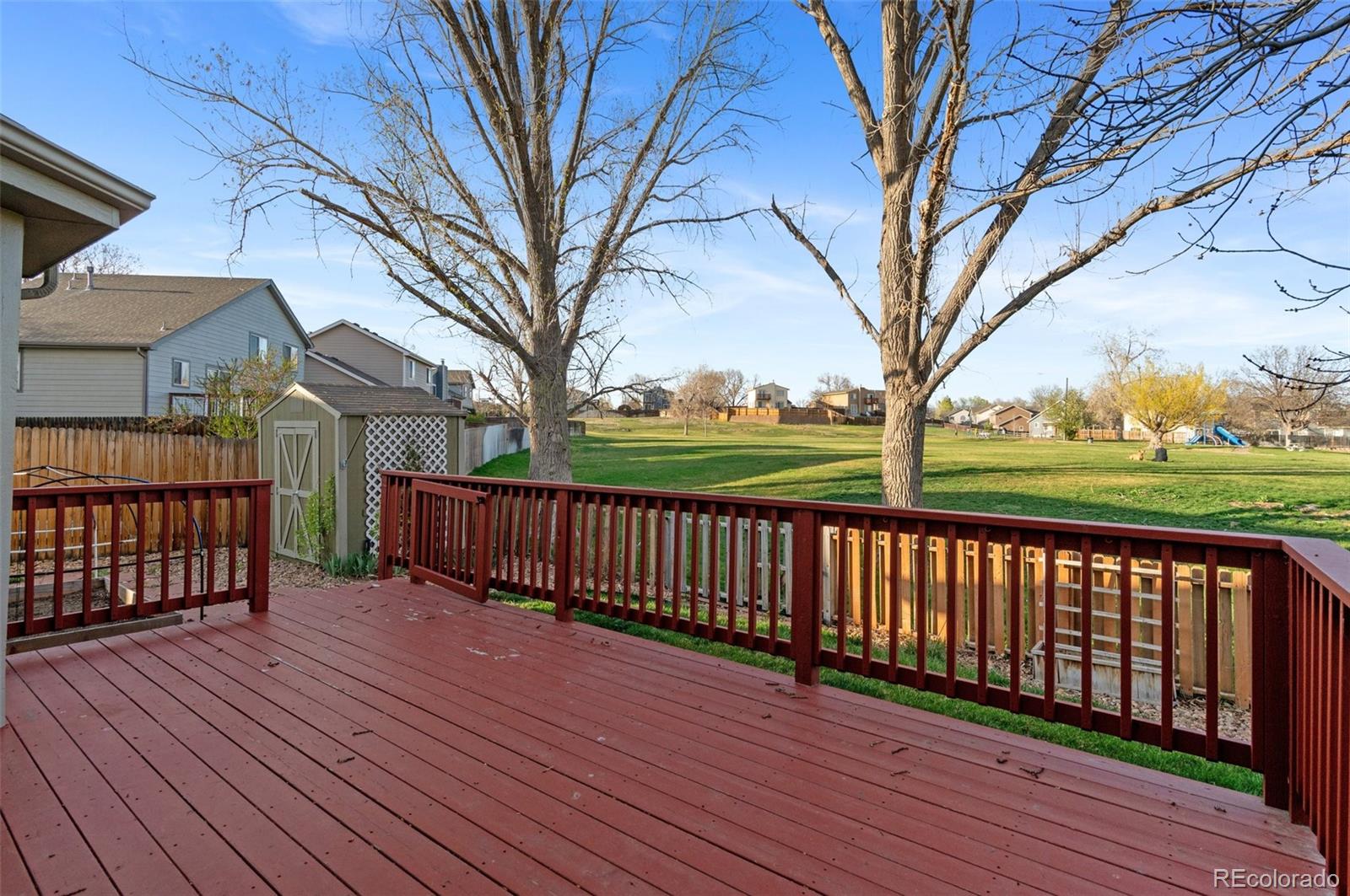 12734 Eudora Drive Thornton, CO 80241 - Photo 36 of 49 a view of a wooden deck with a yard