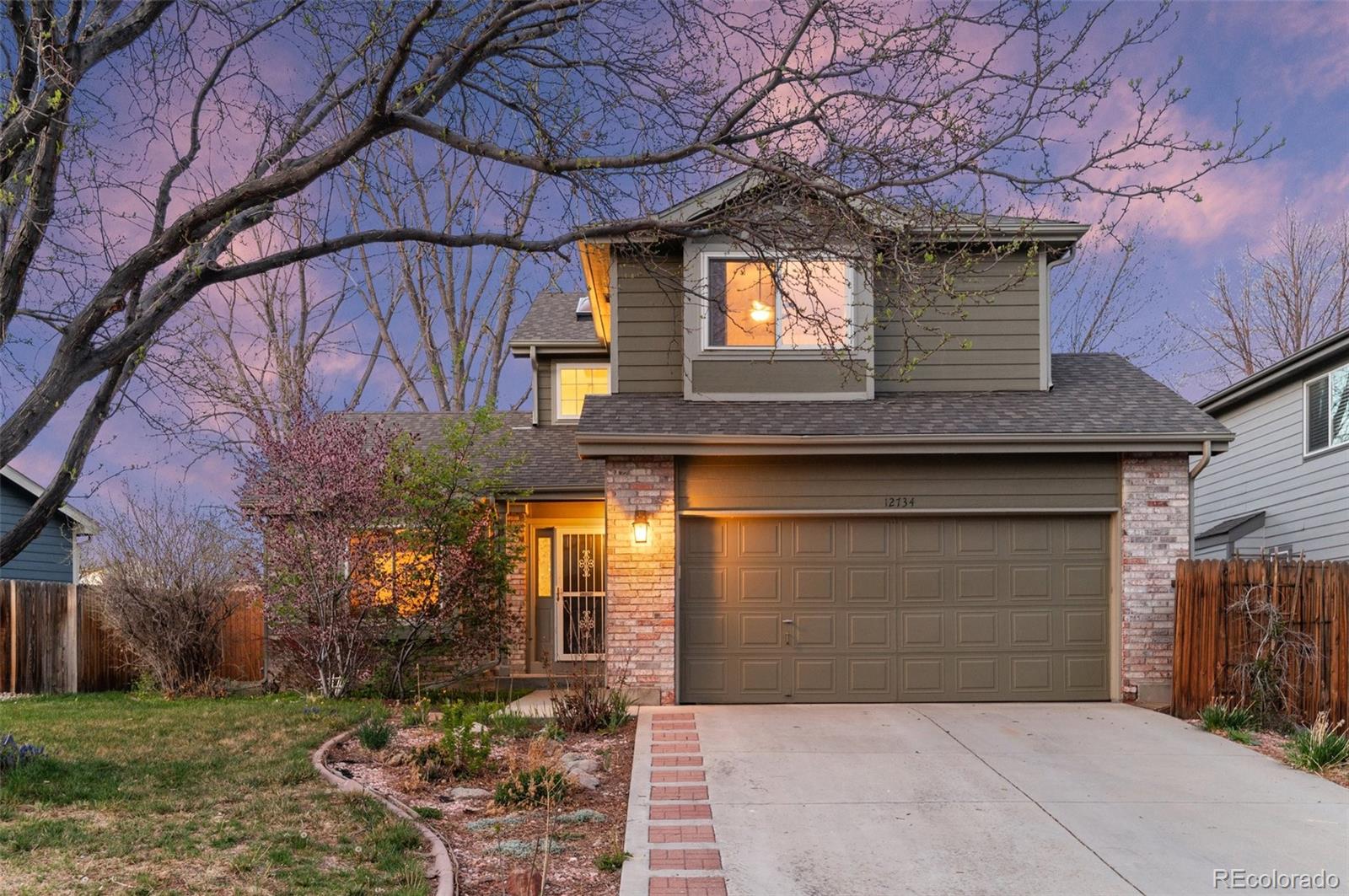 12734 Eudora Drive Thornton, CO 80241 - Photo 4 of 49 a front view of a house with a yard