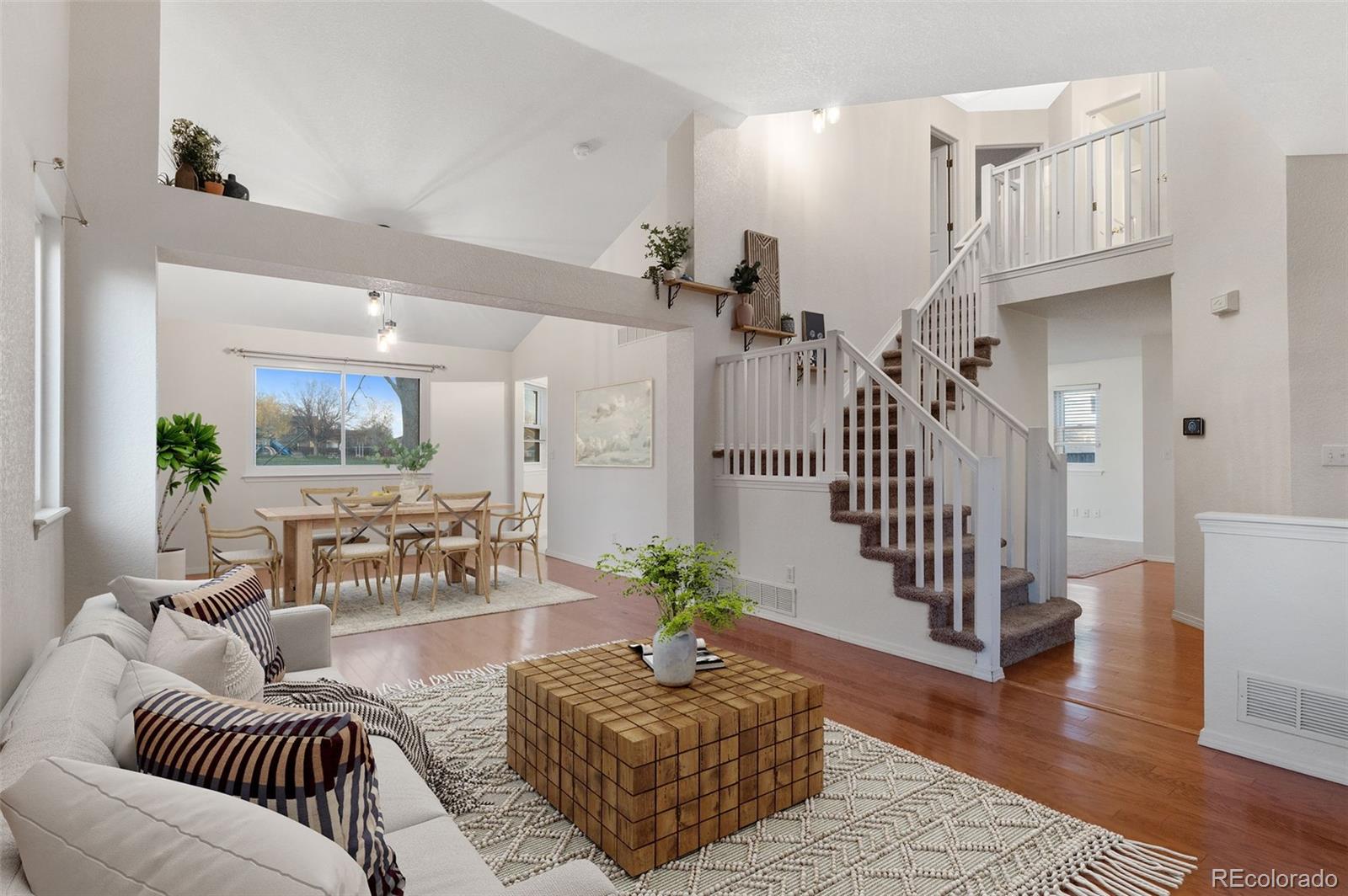 12734 Eudora Drive Thornton, CO 80241 - Photo 6 of 49 a living room with furniture a wooden floor and a rug