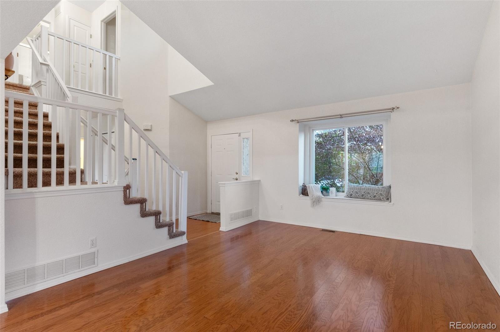 12734 Eudora Drive Thornton, CO 80241 - Photo 9 of 49 a view of entryway and hall with wooden floor