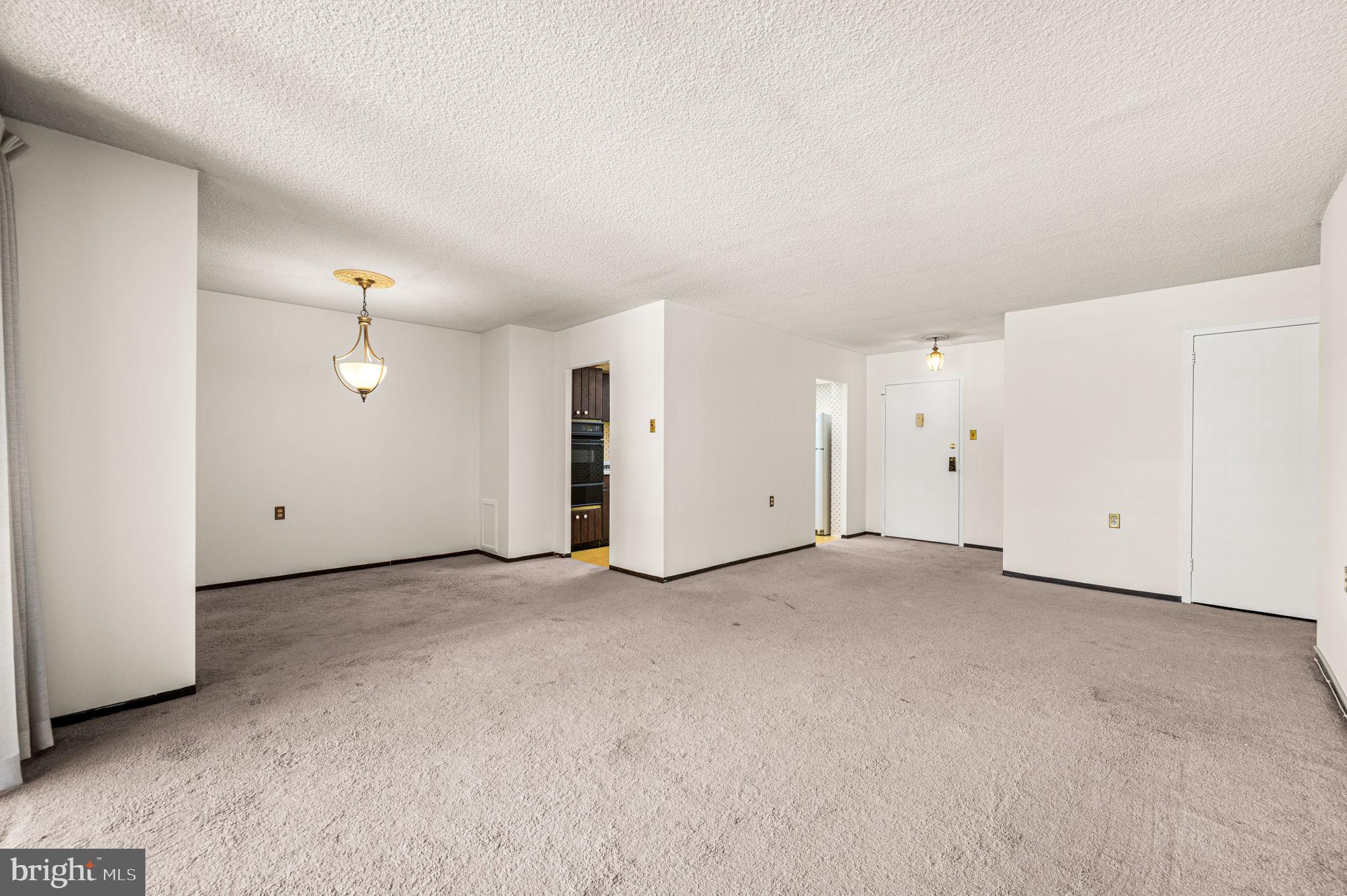 801 Yale Avenue, Unit 511 Swarthmore, PA 19081 - Photo 4 of 28 Living room view into dining area and kitchen.