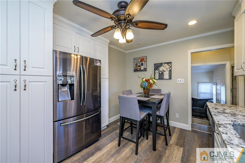 14 Sine Road Edison, NJ 08817 - Photo 14 of 33 a kitchen with stainless steel appliances granite countertop a dining table chairs refrigerator and cabinets