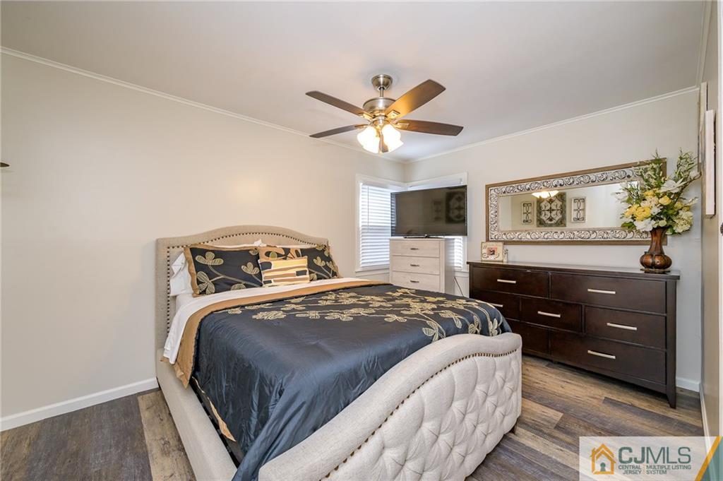 14 Sine Road Edison, NJ 08817 - Photo 15 of 33 a bedroom with a bed and a chandelier