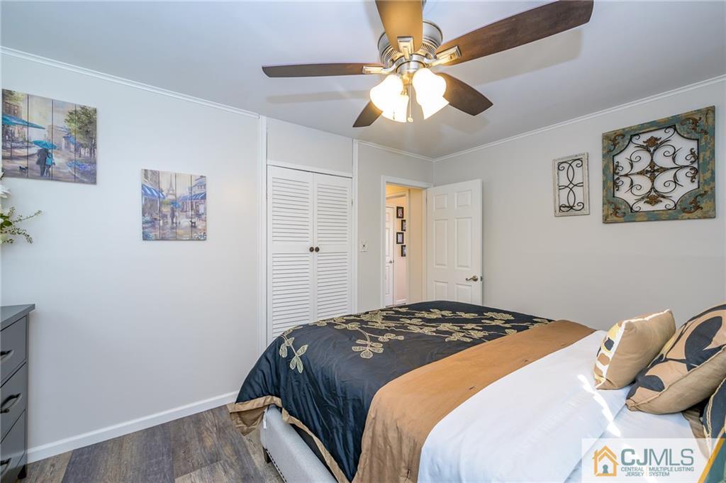 14 Sine Road Edison, NJ 08817 - Photo 18 of 33 a bedroom with a large bed and a chandelier
