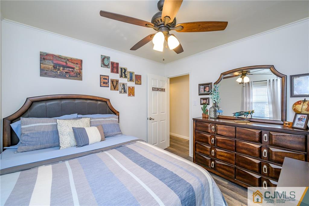 14 Sine Road Edison, NJ 08817 - Photo 21 of 33 a bedroom with a bed and a chandelier
