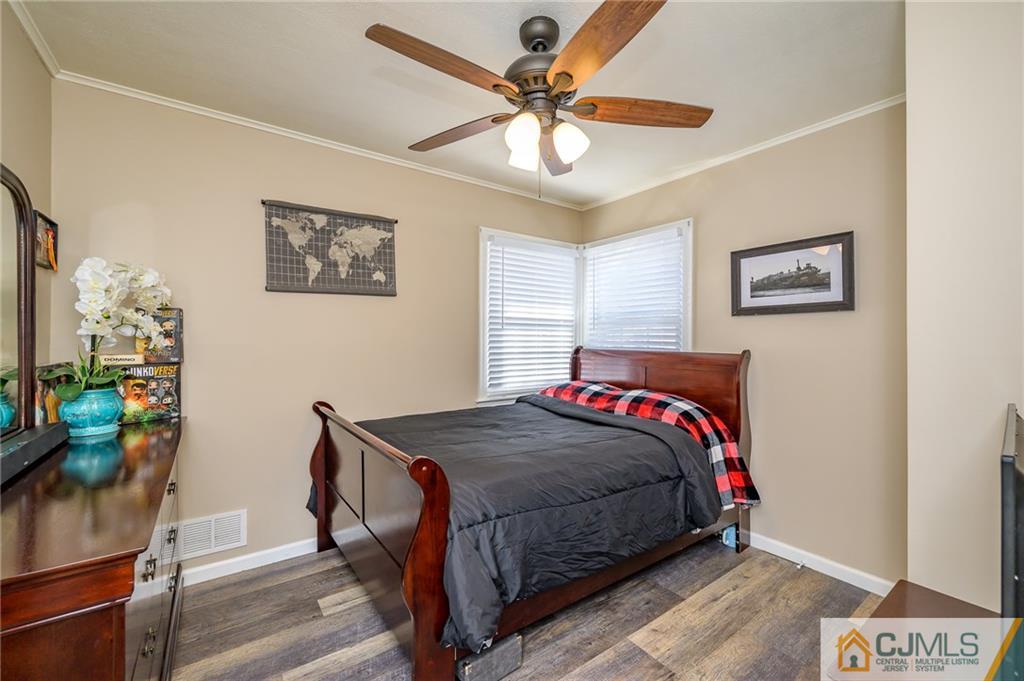 14 Sine Road Edison, NJ 08817 - Photo 22 of 33 a bedroom with a bed and a chandelier