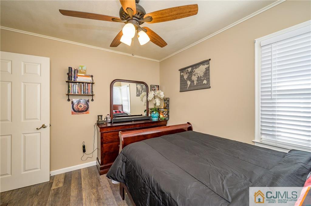 14 Sine Road Edison, NJ 08817 - Photo 24 of 33 a bedroom with a bed and a chandelier