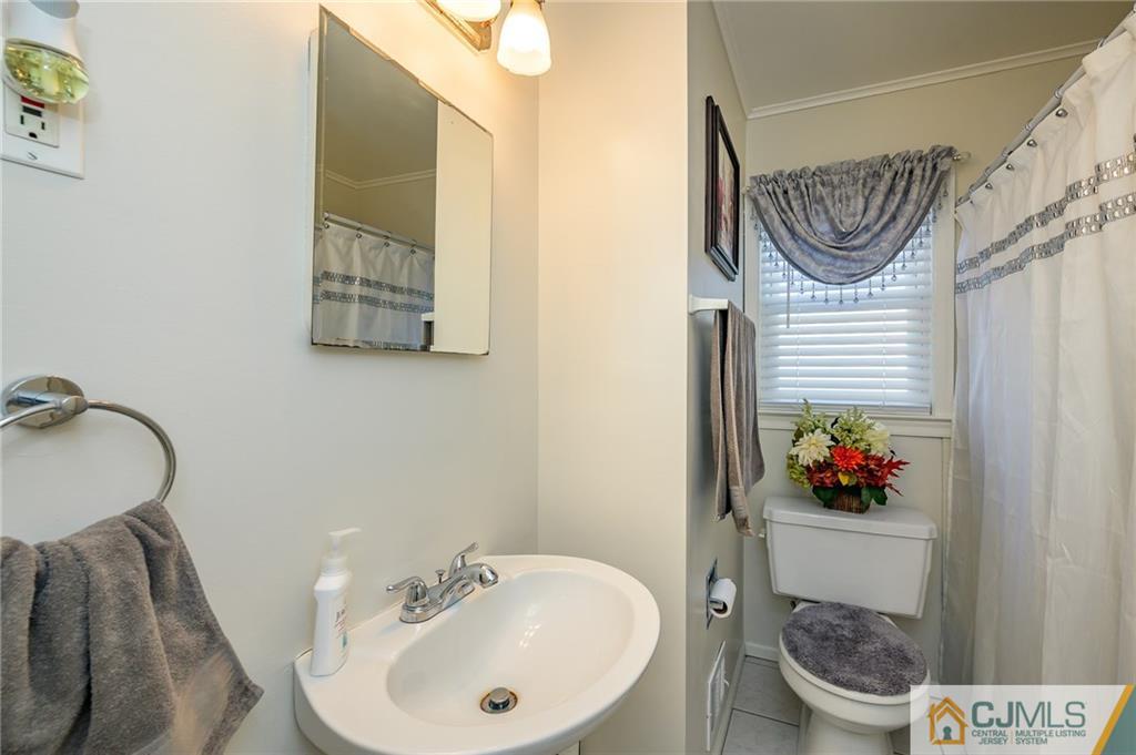 14 Sine Road Edison, NJ 08817 - Photo 25 of 33 a bathroom with a sink and a mirror