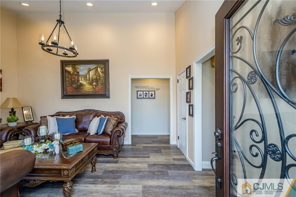 14 Sine Road Edison, NJ 08817 - Photo 4 of 33 a living room with furniture and a chandelier