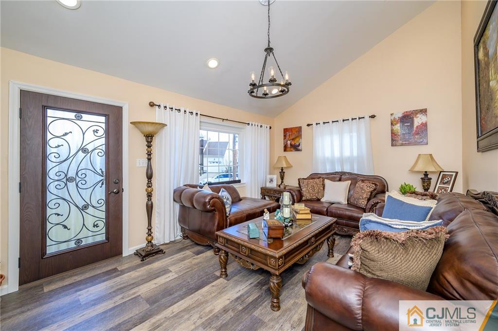14 Sine Road Edison, NJ 08817 - Photo 6 of 33 a living room with furniture a wooden floor and a window