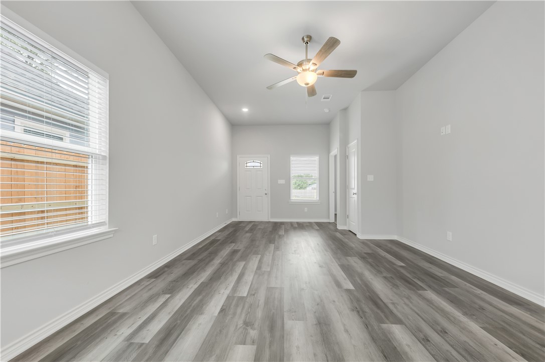 1805 Pin Oak Street Bryan, TX 77803 - Photo 6 of 20 Unfurnished living room featuring wood finished floors, a ceiling fan, and recessed lighting