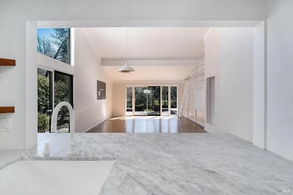 a view of a kitchen with a refrigerator and window