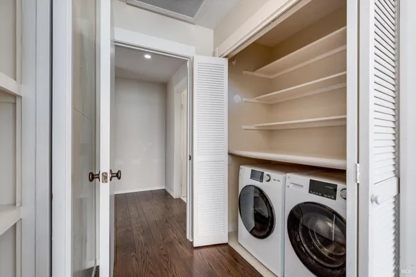 a view of an empty room with wooden floor