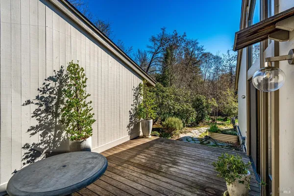 a view of a lush green field with mountains in the background