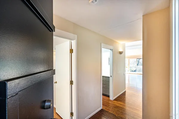 a view of hallway with wooden floor