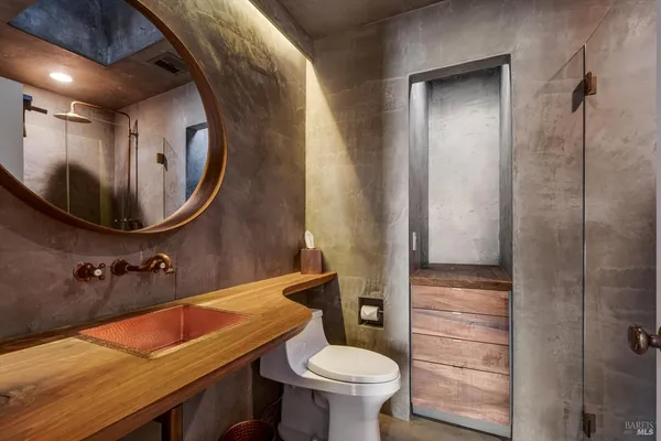 a large kitchen with stainless steel appliances granite countertop a lot of counter space and wooden floors