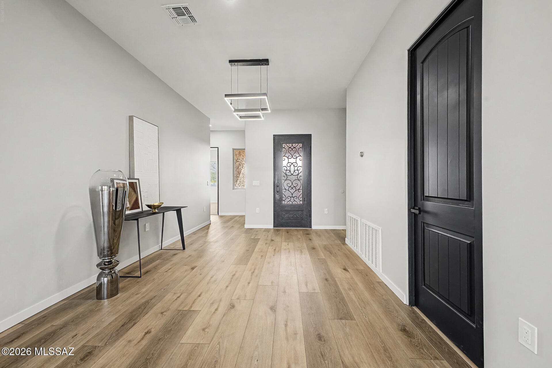 2399 Della Roccia Court Tucson, AZ 85737 - Photo 5 of 34 wooden floor in an empty room with a window