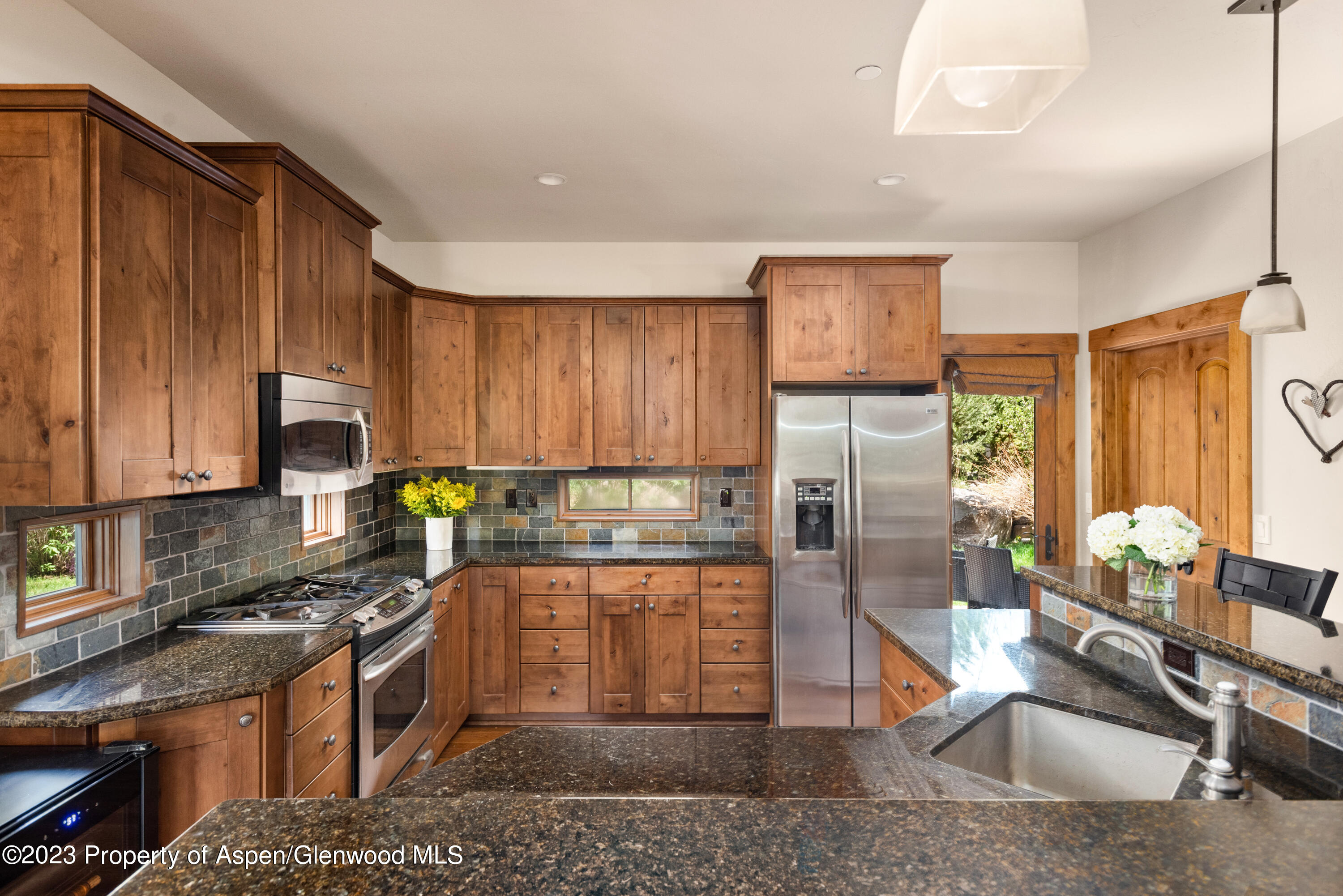 141 Juniper Trail Carbondale, CO 81623 - Photo 3 of 21 a kitchen with stainless steel appliances granite countertop a refrigerator a stove top oven a sink and dishwasher