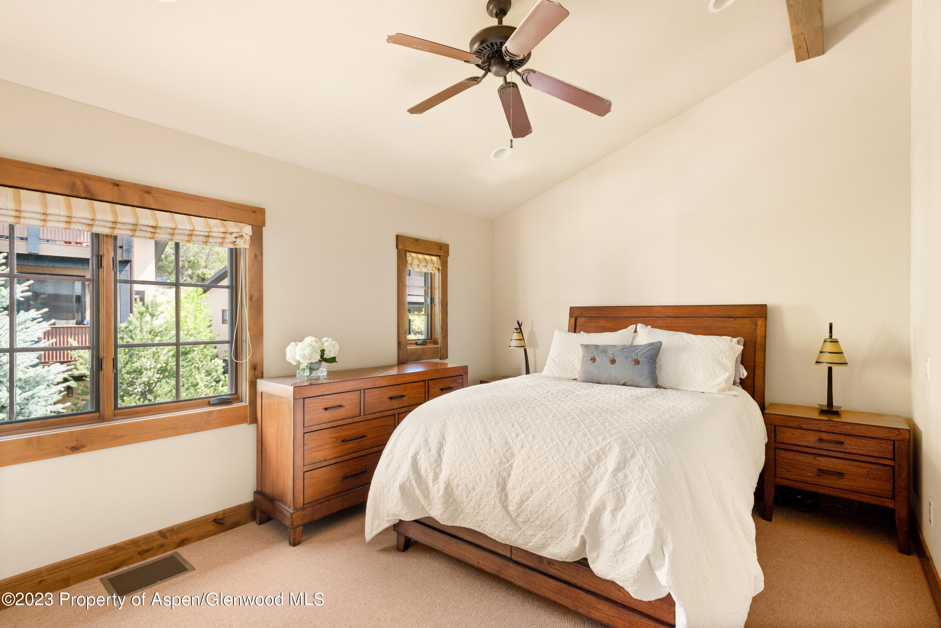 141 Juniper Trail Carbondale, CO 81623 - Photo 8 of 21 a bedroom with a bed a chandelier and a window
