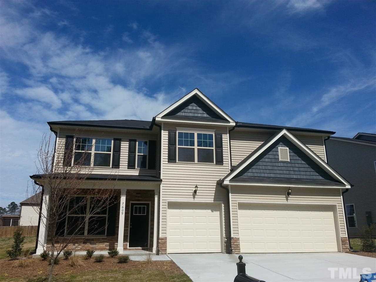 7609 Channery Way Raleigh, NC 27616 - Photo 1 of 25 a front view of a house with garden