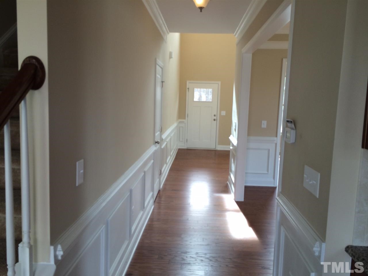 7609 Channery Way Raleigh, NC 27616 - Photo 13 of 25 a view of a hallway with wooden floor and staircase