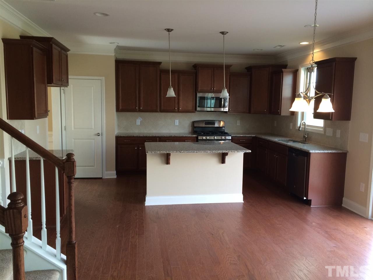 7609 Channery Way Raleigh, NC 27616 - Photo 5 of 25 a kitchen with stainless steel appliances granite countertop a stove a sink and a refrigerator