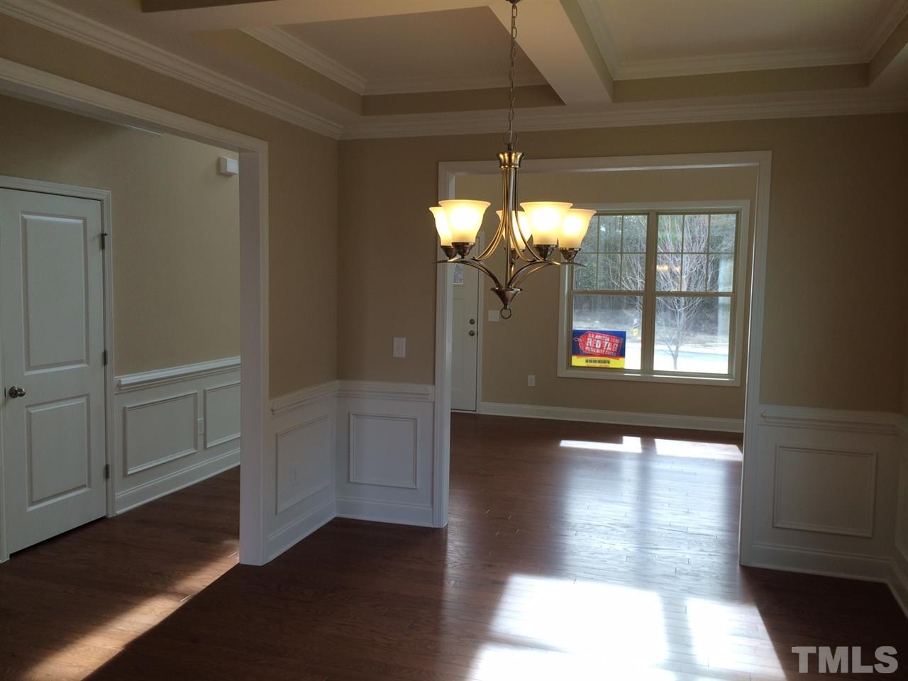 7609 Channery Way Raleigh, NC 27616 - Photo 7 of 25 a view of a hallway with wooden floor and a dining room