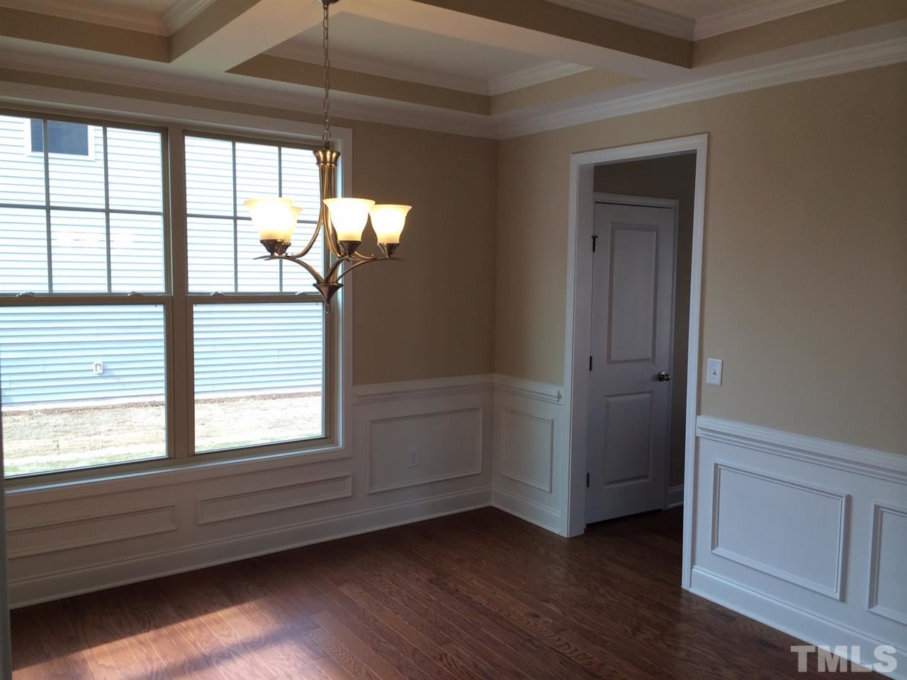 7609 Channery Way Raleigh, NC 27616 - Photo 8 of 25 a view of empty room with wooden floor and fan