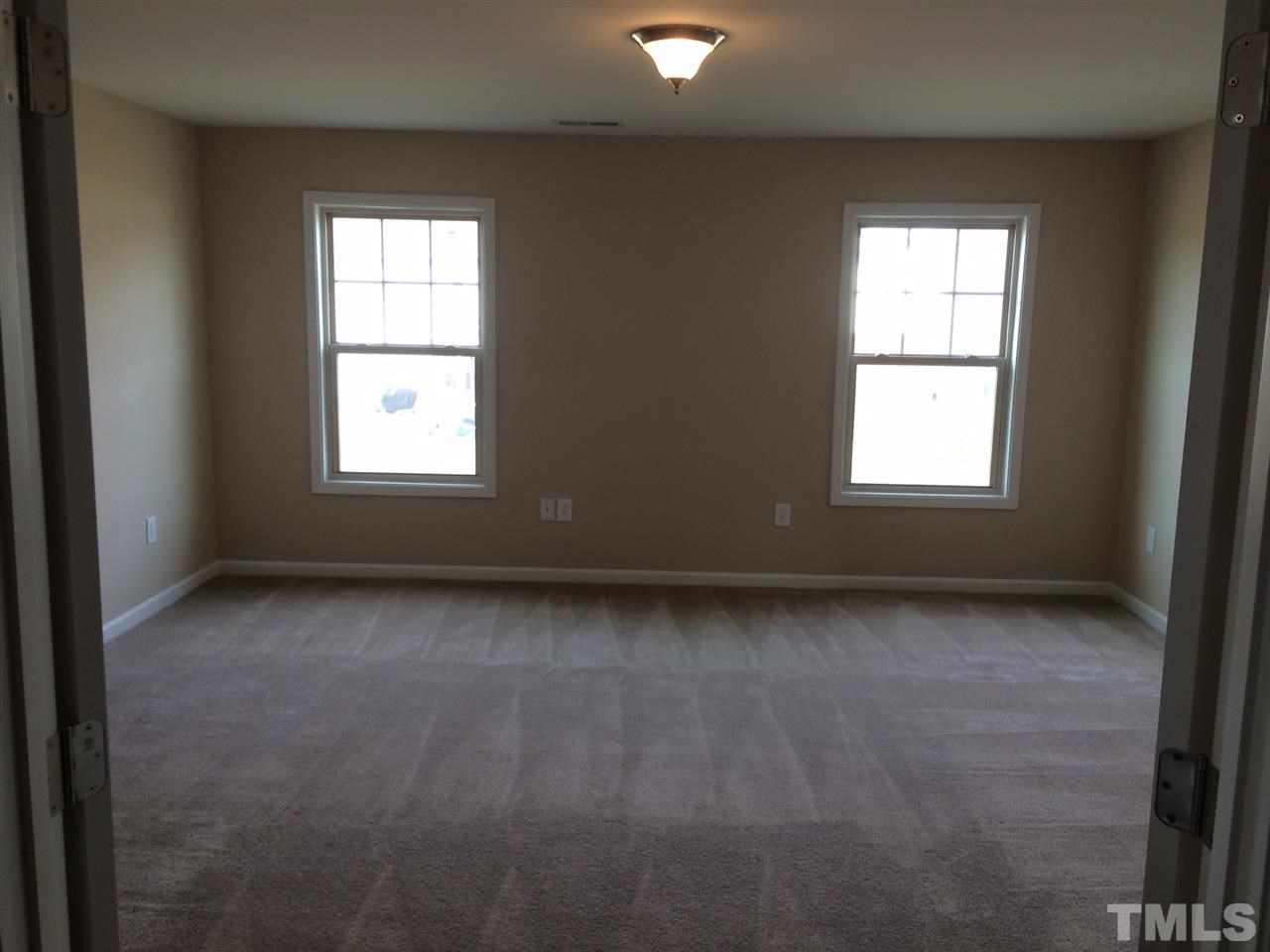 7609 Channery Way Raleigh, NC 27616 - Photo 10 of 25 an empty room with a window