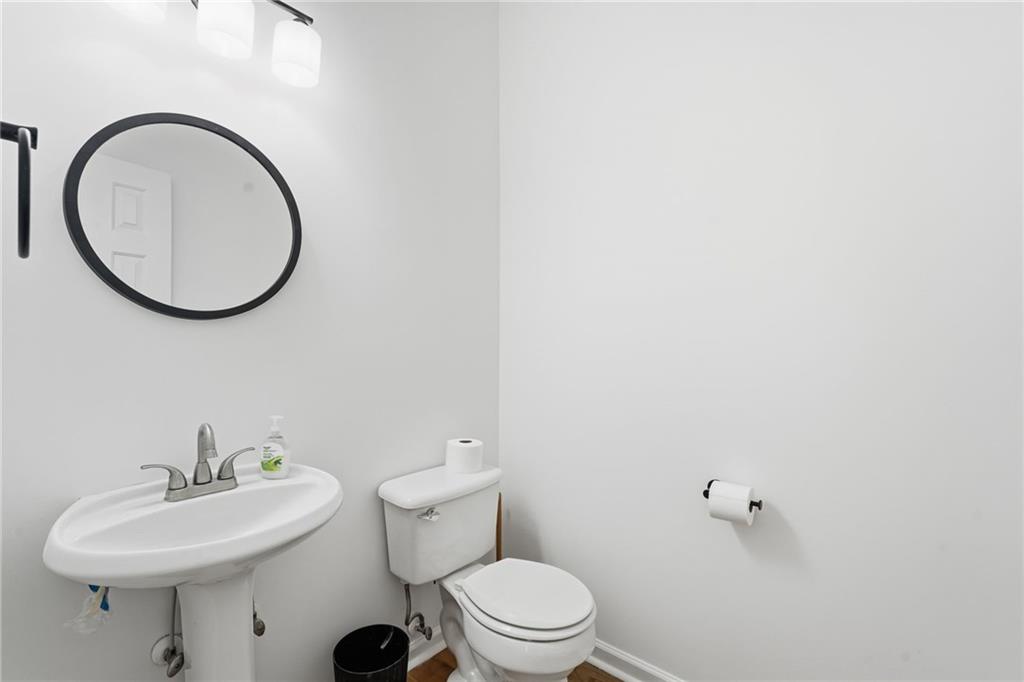 205 Towne Ridge Drive Woodstock, GA 30188 - Photo 18 of 56 a bathroom with a sink a mirror and a toilet