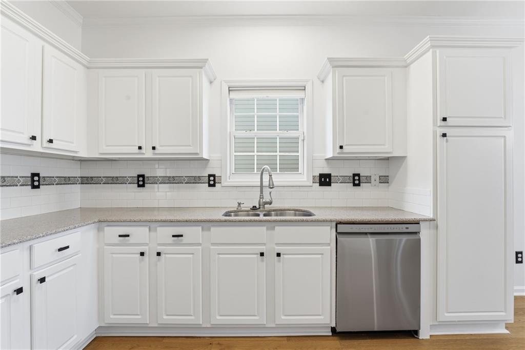 205 Towne Ridge Drive Woodstock, GA 30188 - Photo 20 of 56 a kitchen with white cabinets and white appliances