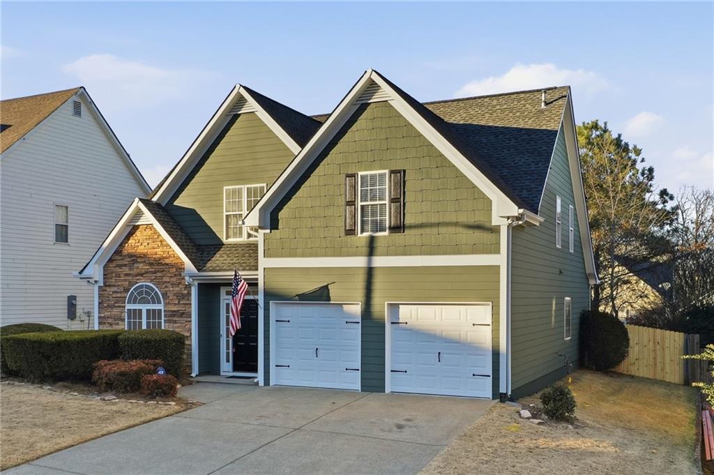 205 Towne Ridge Drive Woodstock, GA 30188 - Photo 2 of 56 a view of a house with a garage and yard