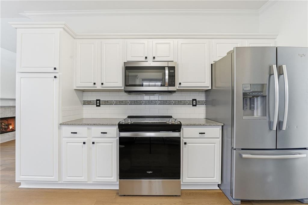 205 Towne Ridge Drive Woodstock, GA 30188 - Photo 21 of 56 a kitchen with cabinets stainless steel appliances and a counter space