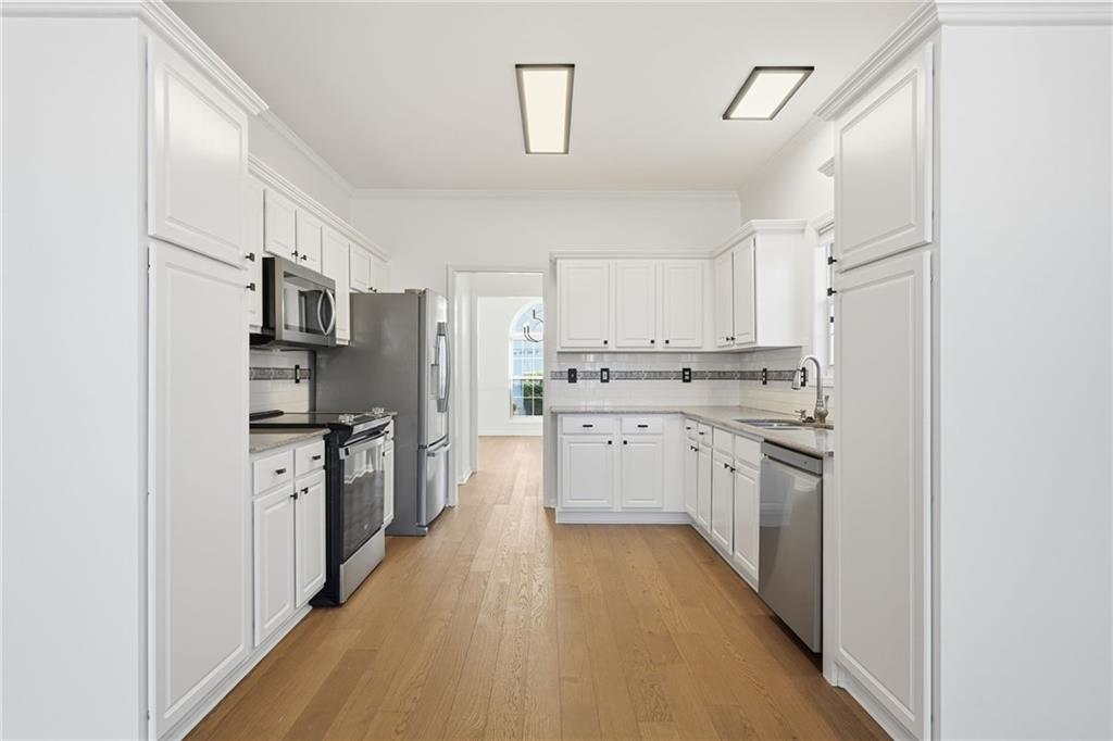 205 Towne Ridge Drive Woodstock, GA 30188 - Photo 23 of 56 a kitchen with stainless steel appliances a refrigerator sink and cabinets