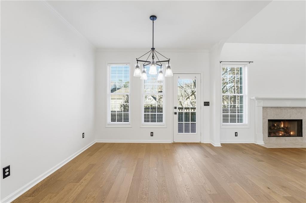 205 Towne Ridge Drive Woodstock, GA 30188 - Photo 24 of 56 a view of an empty room with wooden floor and a window