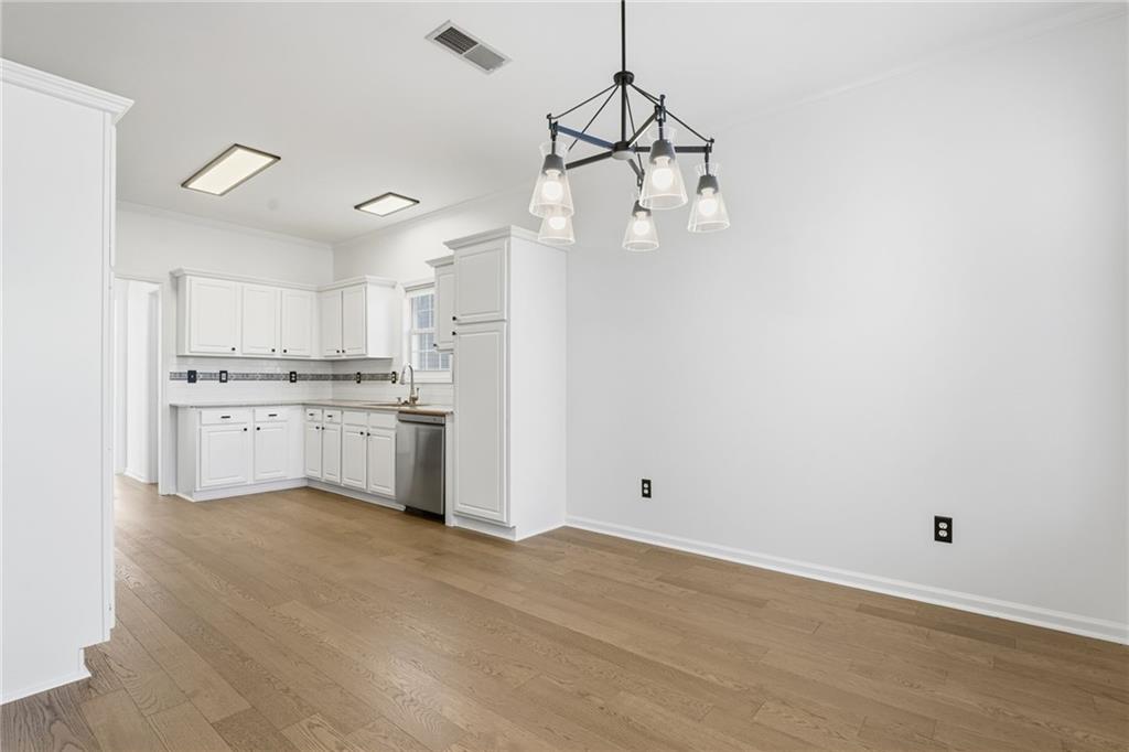 205 Towne Ridge Drive Woodstock, GA 30188 - Photo 27 of 56 a view of a kitchen with a sink dishwasher a refrigerator and white cabinets