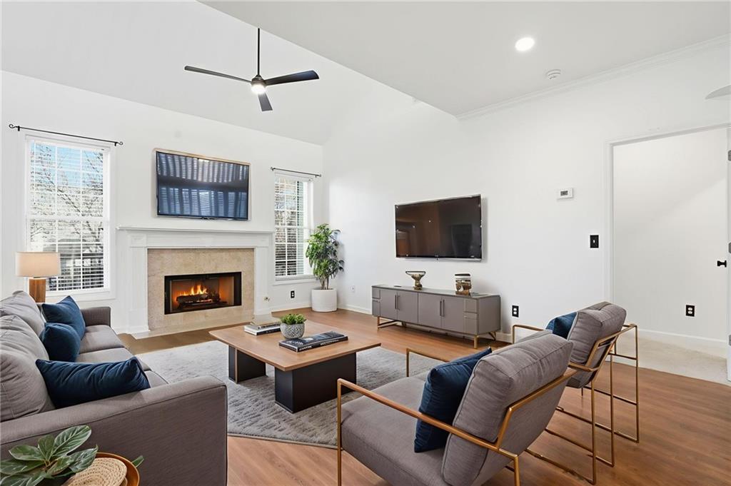 205 Towne Ridge Drive Woodstock, GA 30188 - Photo 29 of 56 a living room with furniture a flat screen tv and a fireplace