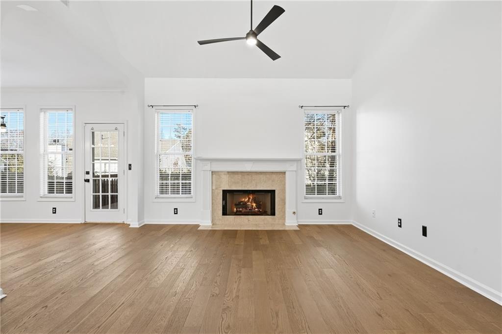205 Towne Ridge Drive Woodstock, GA 30188 - Photo 30 of 56 a view of an empty room with wooden floor fireplace and a window