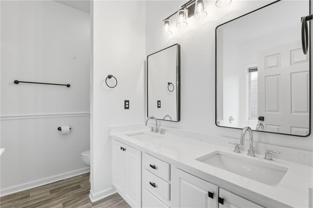 205 Towne Ridge Drive Woodstock, GA 30188 - Photo 36 of 56 a bathroom with double vanity sink and a mirror