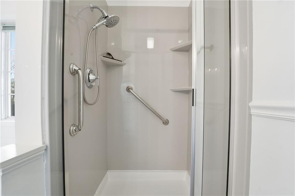 205 Towne Ridge Drive Woodstock, GA 30188 - Photo 38 of 56 a bathroom with a glass shower door